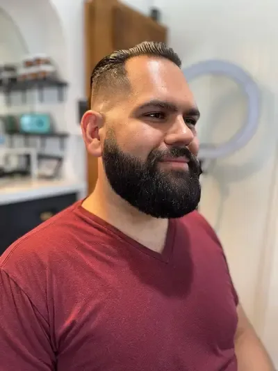 A man with a beard who just got a professional beard trim with a straight razor line up in Richmond, Virginia